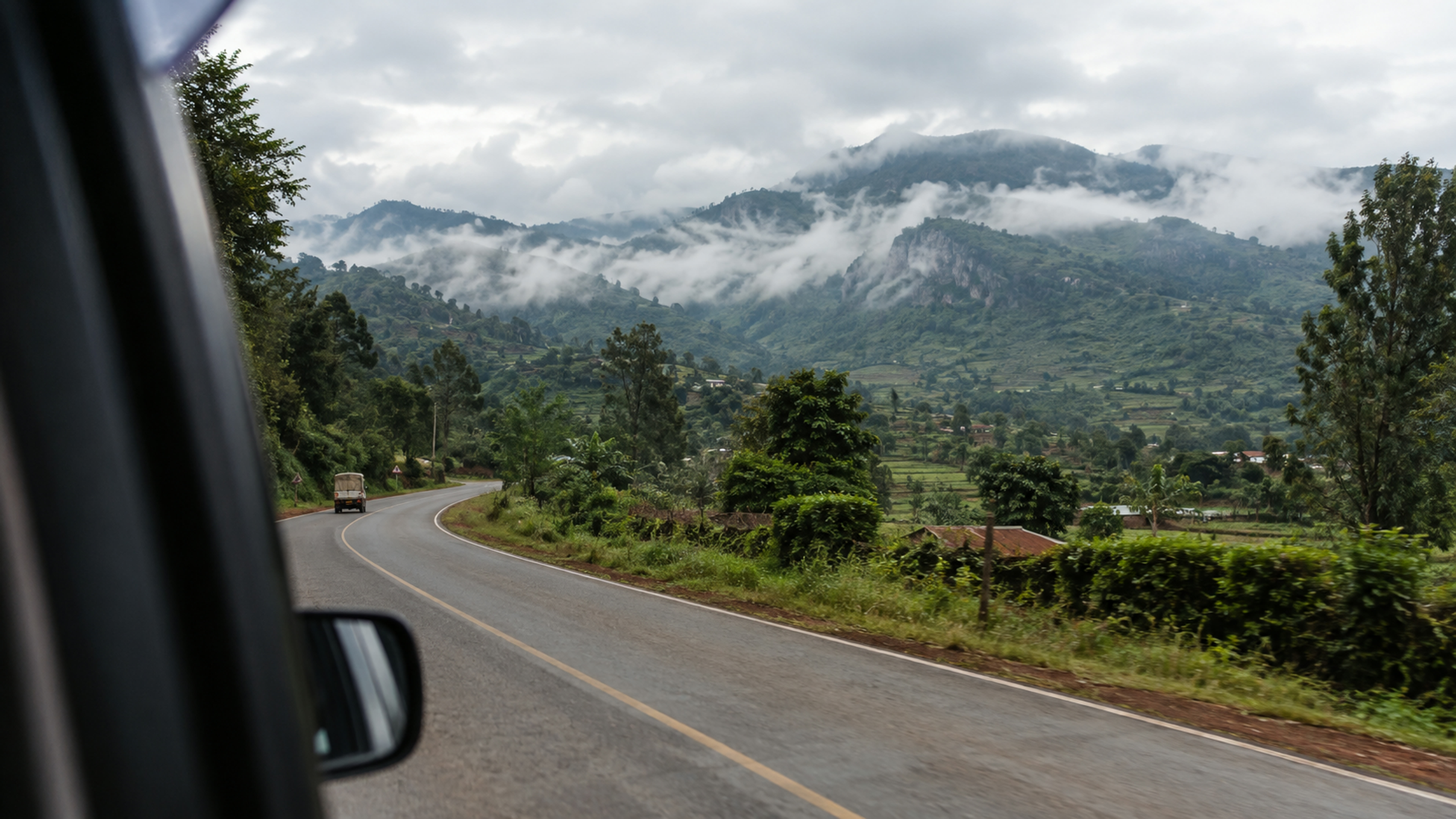 A winding road into green hills, no identifiable people.